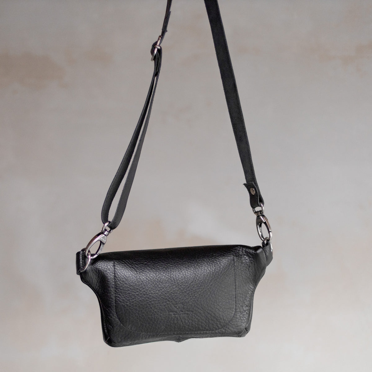 Sac à main banane en cuir noir, vu de face, poche zippée